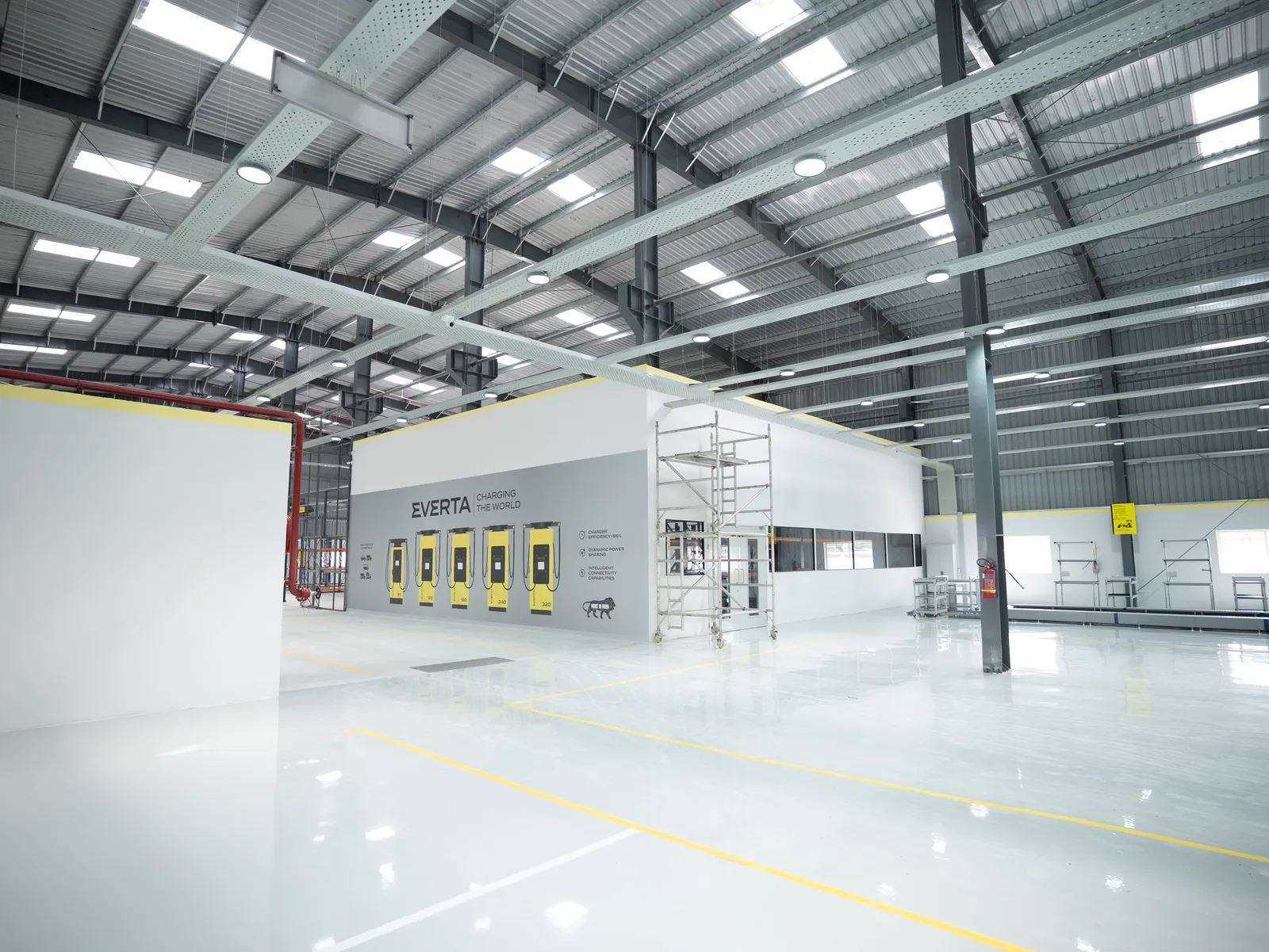 Factory floor with Everta display wall and steel structure — Everta